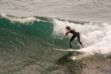Surfer in Ribeira de Ilhas Beach in Ericeira Portugal.