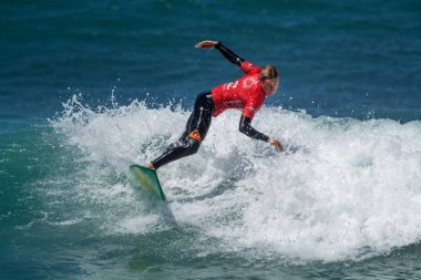 Surfer in Ribeira de Ilhas Beach in Ericeira Portugal.