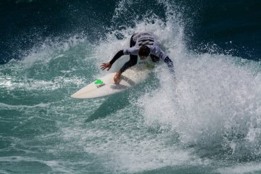 Surfer in Ribeira de Ilhas Beach in Ericeira Portugal.