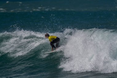 Surfer in Ribeira de Ilhas Beach in Ericeira Portugal.