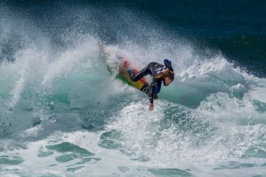 Surfer in Ribeira de Ilhas Beach in Ericeira Portugal.