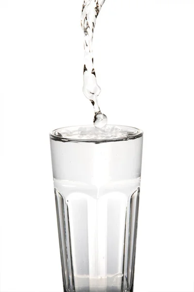 Glass water with water beeing droped — Stock Photo, Image