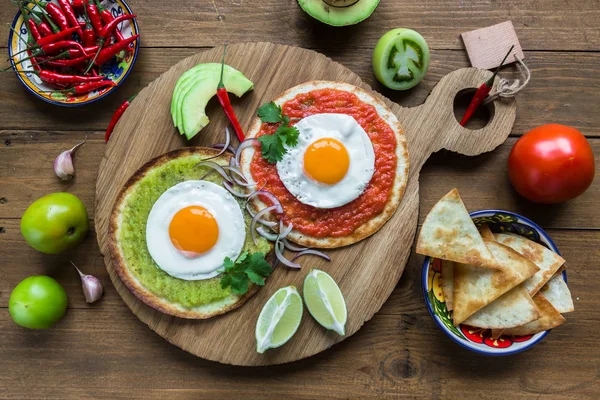 Huevos divorciados, fritos en tortillas de maíz con salsa verde y roja —  Fotos de Stock