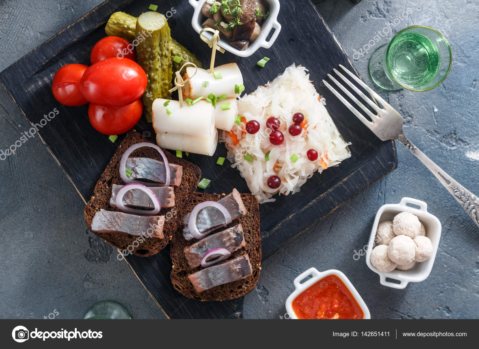 Vodka with various traditional snacks and appetizers pickled cabbage