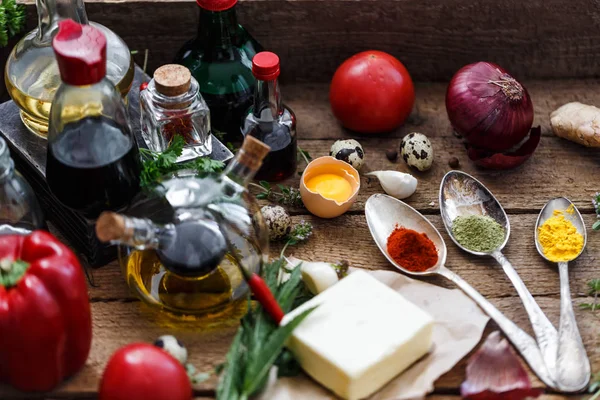 Various spices, oils and sauces selection on wooden background