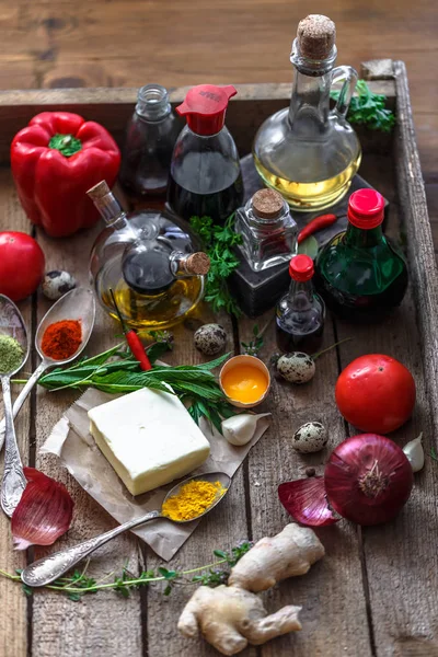 Various spices, oils and sauces selection on wooden background