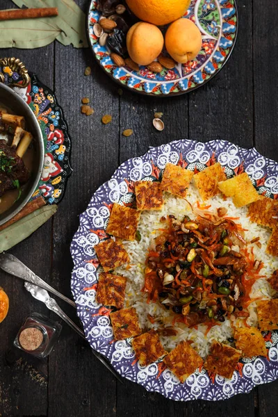 Arroz iraní rematado con ralladura de naranja, nueces y pasas en plato tradicional —  Fotos de Stock