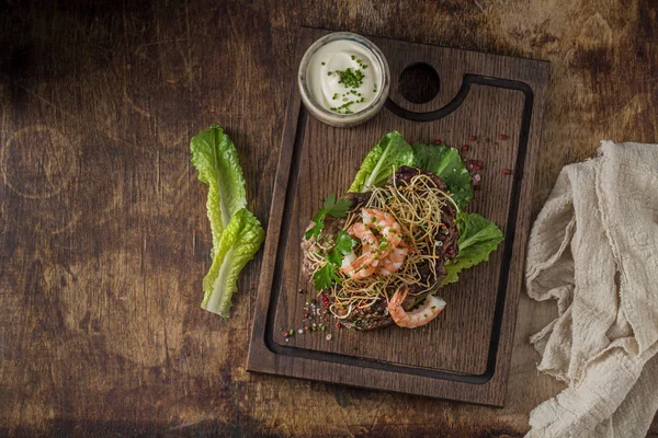 Grilled surf and turf on wooden board