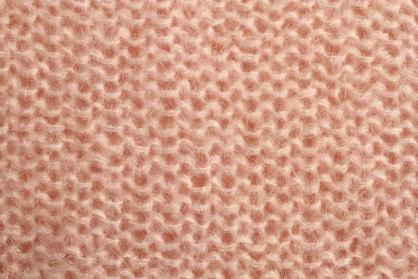 Tessuto di lana lavorata a maglia rosa chiaro. Macro . — Foto Stock