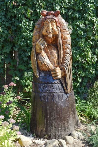 A fából készült szobor Baba Yaga egy mozsárban. Mese karakterek Baba Yaga, fa dekoráció — Stock Fotó