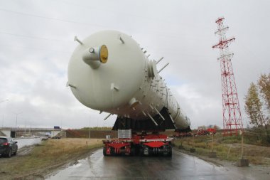 Transportation distillation column on the way to a petrochemical plant. Equipment for rectification clipart