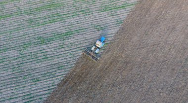 Top view of the tractor that plows the field. disking the soil. Soil cultivation after harvest clipart