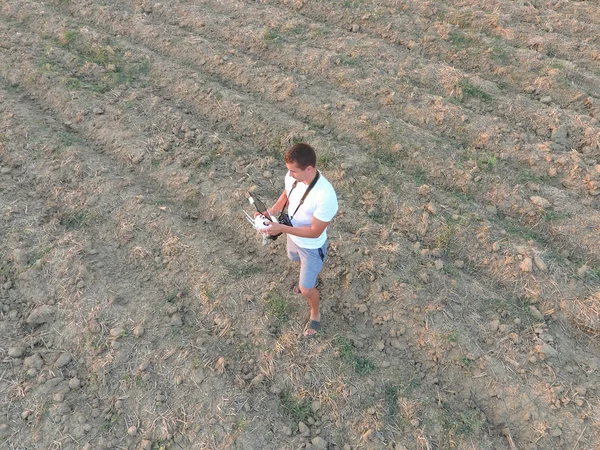 O homem está a segurar um comando remoto dos quadricópteros. Trabalho do fotógrafo com gadgets — Fotografia de Stock