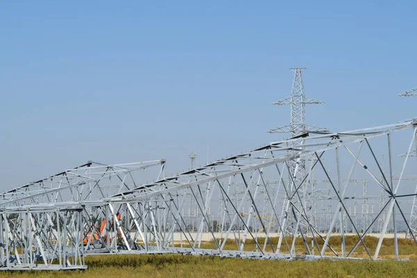 Power line support, insulators and wires. Appearance of a design. Assembly and installation of new support and wires of a power line