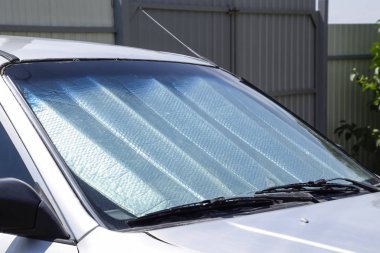 Sun Reflector windscreen. Protection of the car panel from direct sunlight clipart