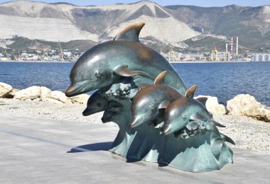 Sahilde üç yunuslar bronz heykel.