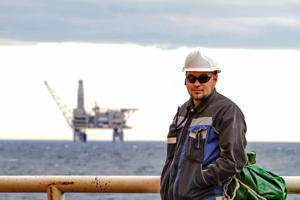 Petrolcü shift işçiler arka planda offshore geminin güvertesinde raf planforms petrol. İşe giderken iş