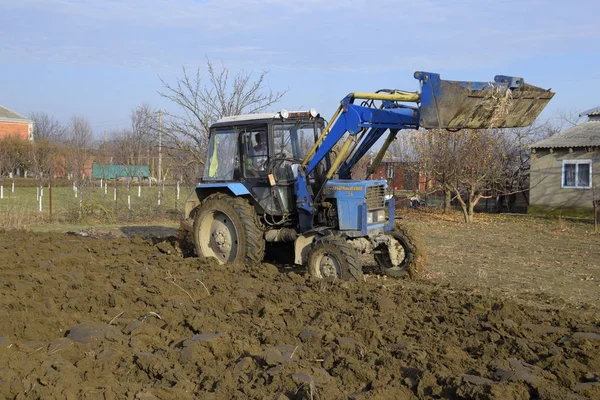 Tractor plowing the garden. Plowing the soil in the garden.