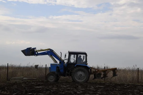 Tractor plowing the garden. Plowing the soil in the garden.