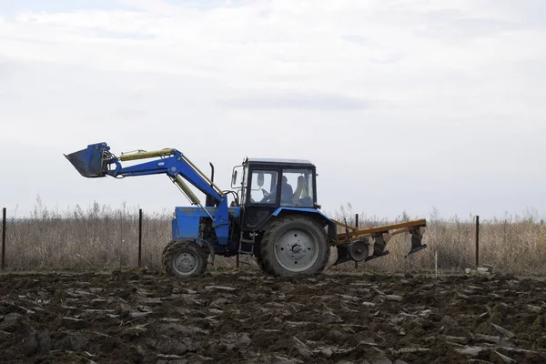 Tractor plowing the garden. Plowing the soil in the garden.