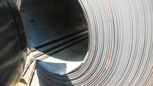 Steel sheets rolled up into rolls. Export Steel. Packing of steel for transportation.