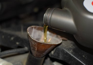 Otomobilin motor yağ değişimi. Huni yağ doldurma. Araba bakım istasyonu