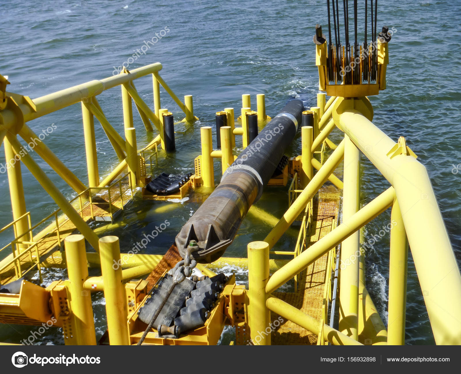 Laying of pipes with pipelaying barge crane near the shore. Descent of