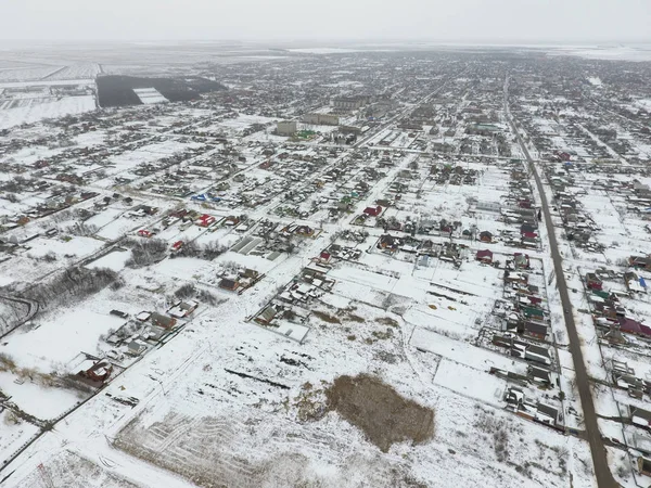 Winter view from the bird's eye view of the village. The streets are covered with snow.