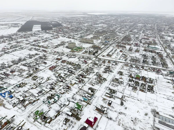 Winter view from the bird\'s eye view of the village. The streets are covered with snow.