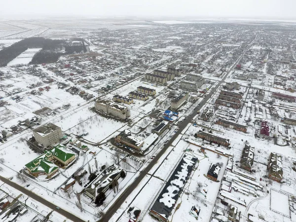 Winter view from the bird\'s eye view of the village. The streets are covered with snow.