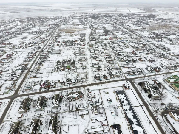 Winter view from the bird\'s eye view of the village. The streets are covered with snow.