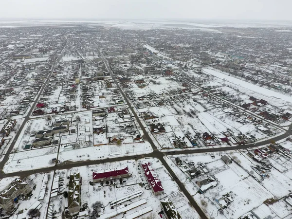 Winter view from the bird\'s eye view of the village. The streets are covered with snow.