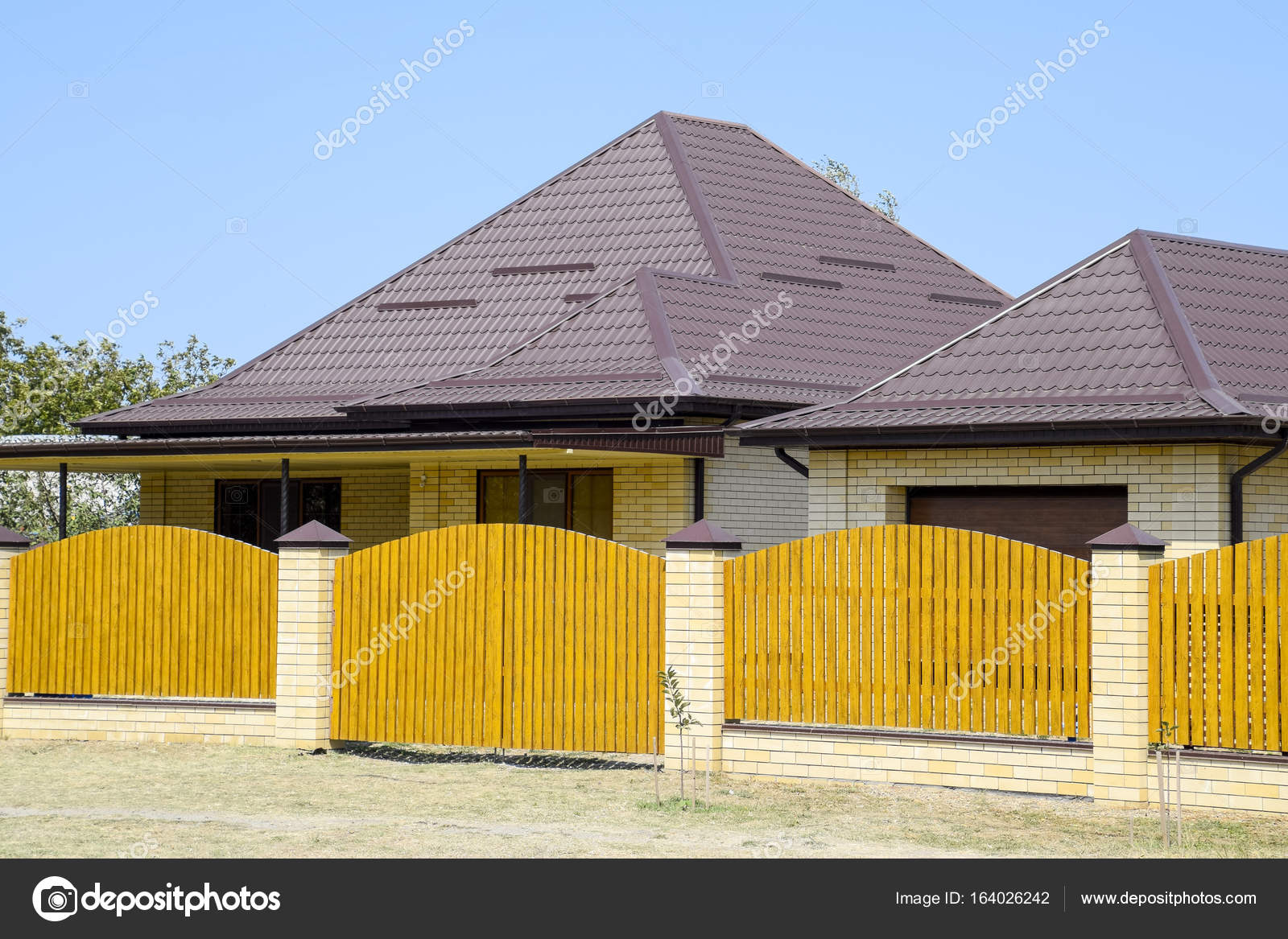 Brick House With Corrugated Metal Profile Roof And Wooden Fence Beautiful View Of The Facade Style Of Design P O By Leonid_eremeychuk Brick House With Corrugated Metal Profile Roof And Wooden Fence Beautiful View Of The Facade Style Of Design P O By Leonid_eremeychuk