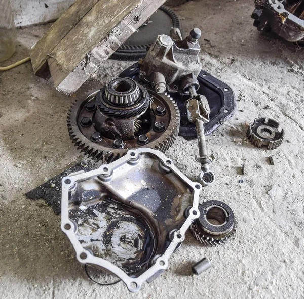 Dismantled box car transmissions. Gear with bearings and gearbox housing. The gears on the shaft of a mechanical transmission.