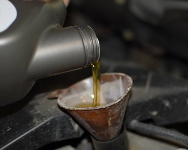 Otomobilin motor yağ değişimi. Huni yağ doldurma. Araba bakım istasyonu.