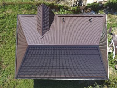 A view from above on the roof of the house. The roof of corrugated sheet. Roofing of metal profile wavy shape clipart