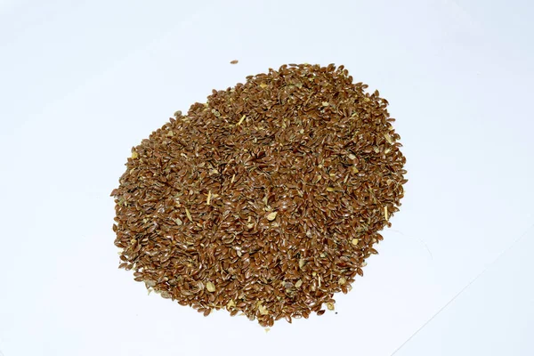 Flax seeds. Storage of flax seeds. Flax, essential oil culture. A handful of flax seeds