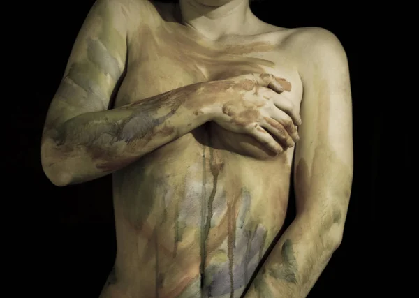 Body art. Drawing on the body. Beautiful girl with painted body watercolors. A white young girl painted the body with paint