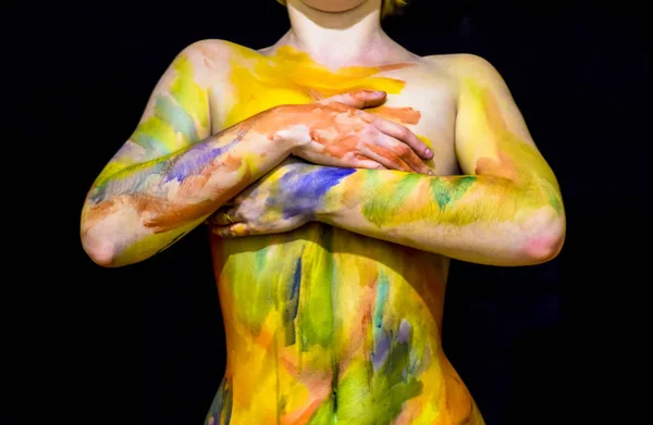 Body art. Drawing on the body. Beautiful girl with painted body watercolors. A white young girl painted the body with paint.