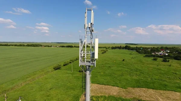 Cellular tower. Equipment for relaying cellular and mobile signal. Fly around up and down.