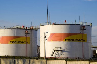 Rezervuarlar Rosneft yağ depo yakıt ile. Batan güneşin ışığında tankları.