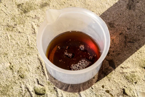 Pouring thick glyphosate solution in a beaker — Stock Photo, Image