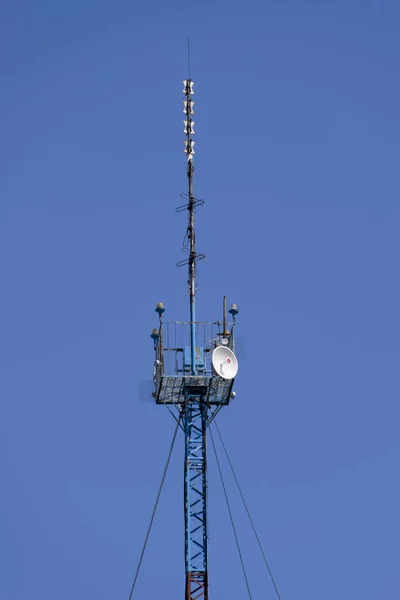 Коммуникационная башня с ретрансляторами и спутниковой антенной — стоковое фото