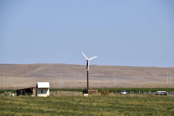 Wind power plant. A wind turbine in the field for generating electricity