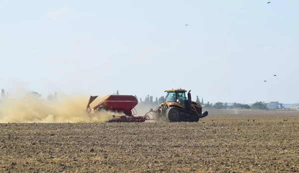 Tracteur roule sur le terrain et fait l'engrais dans le sol. Engrais après labourage du champ . — Photo