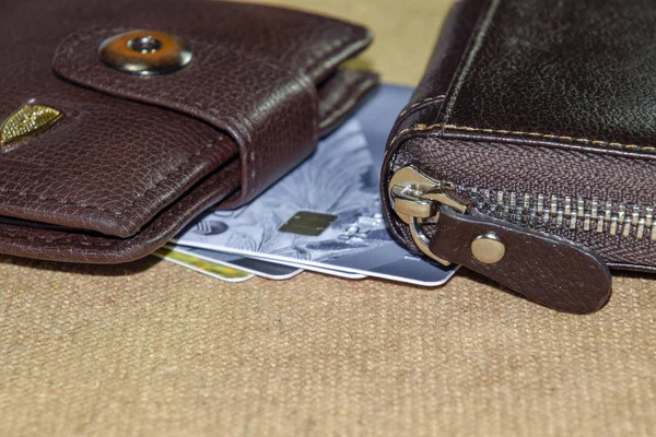 Brown leather wallet with credit and discount cards.