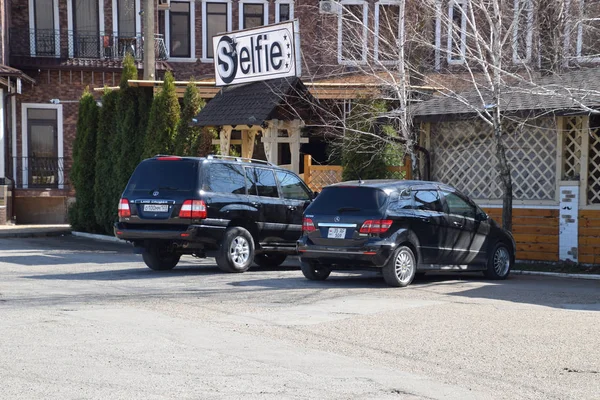 Land Cruiser Prado de Toyota, y Mercedes b200. El coche está aparcado cerca del café. . — Foto de Stock