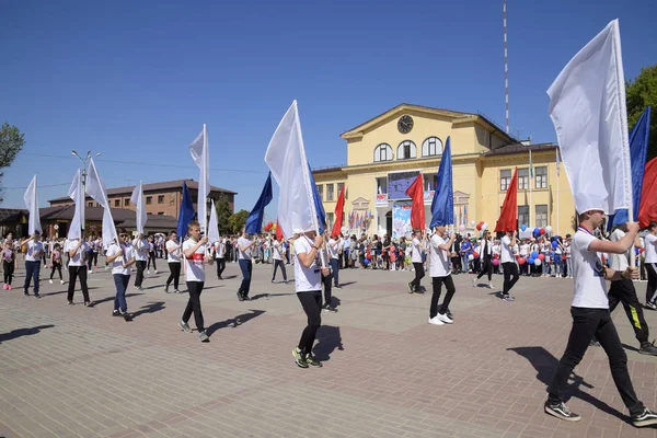 Jóvenes deportistas de las escuelas deportivas de la ciudad. Celebrando el primero de mayo, el día de la primavera y el trabajo. Desfile del Primero de Mayo en la Plaza del Teatro en la ciudad de Slavyansk-on-Kuban . — Foto de Stock