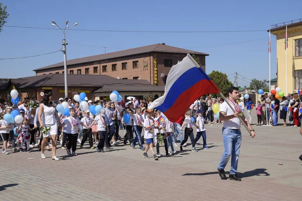 Jóvenes deportistas de las escuelas deportivas de la ciudad. Celebrando el primero de mayo, el día de la primavera y el trabajo. Desfile del Primero de Mayo en la Plaza del Teatro en la ciudad de Slavyansk-on-Kuban . — Foto de Stock