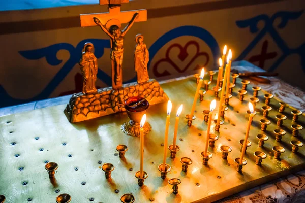 Orthodox church from the inside. Burning wax candles in front of icons and frescoes. Christian religion. — Stock Photo, Image